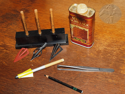 A collection has to be well documented or it's worth nothing! I prefer the hand written descriptions over stickers. I use the same system on my wooden bows. Some sort of fat-pencil (Cajal) with a single coat (dip) of shellack. It will not run and works nice on all kinds of surfaces. It is also not effected by oil, which should be used occasionally on the broadheads themselfs   © Falk 2012